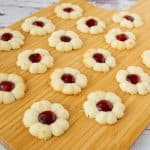 A wooden board with jam cookies