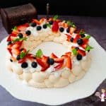 A pavlova wreath on a cake stand