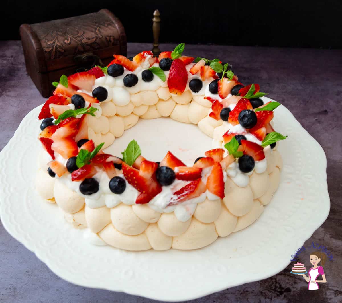 A pavlova wreath on a cake stand