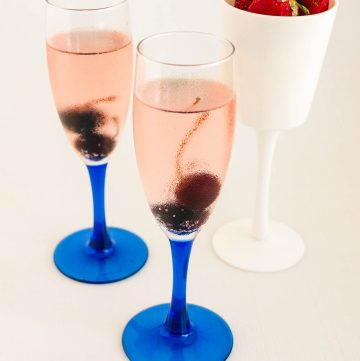 Cherry champagne cocktail in a champagne glass