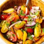 A wooden bowl with tomato salad.