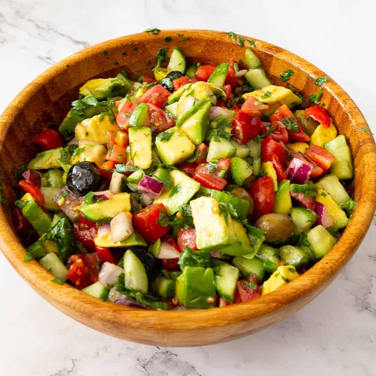 Avocado salad with veggies in a bowl.