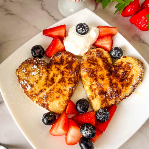 A French Toast for Valentine's Day on a white plate.