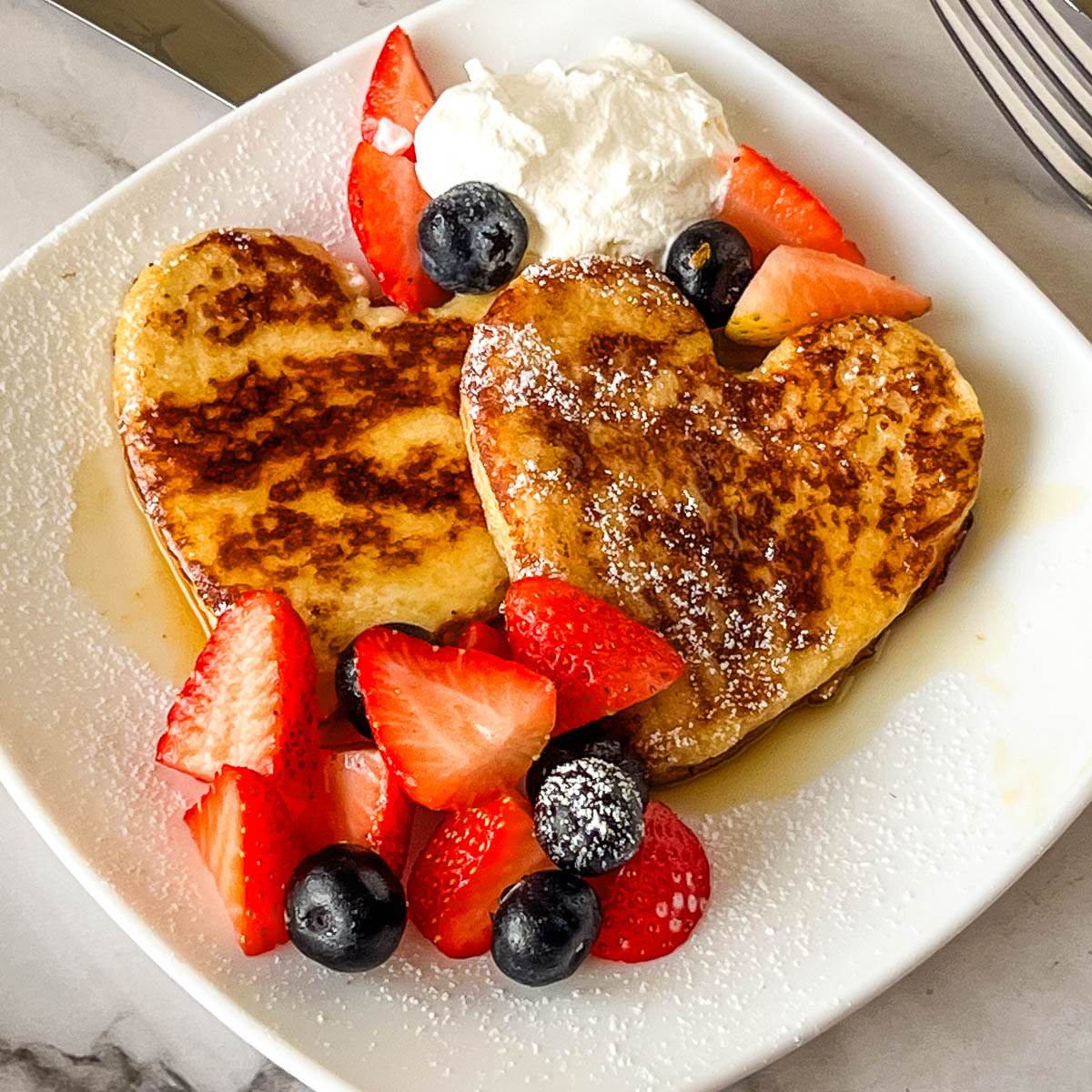 Valentines Day French Toast on a white plate.