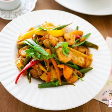 A white plate with stir fry