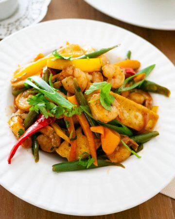 A white plate with stir fry