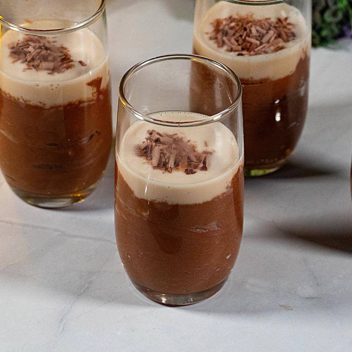A dessert glass with chocolate mousse.