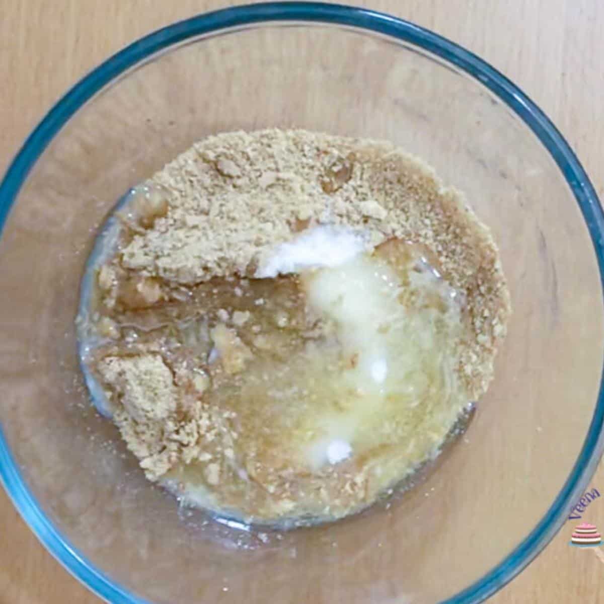 Graham crackers and melted butter in a bowl