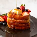 4 slices of French toast on a black plate