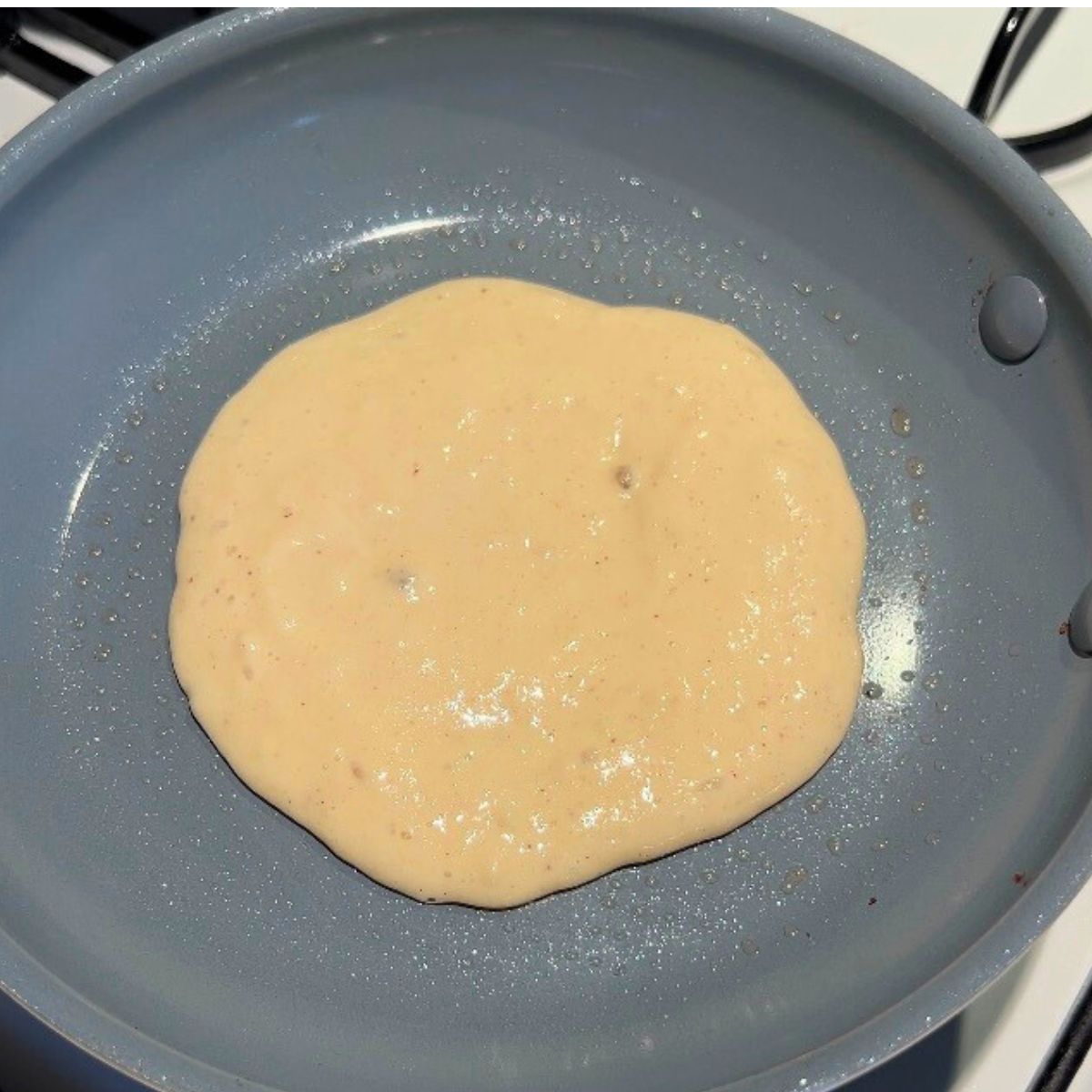 Buttermilk pancake in a frying pan.
