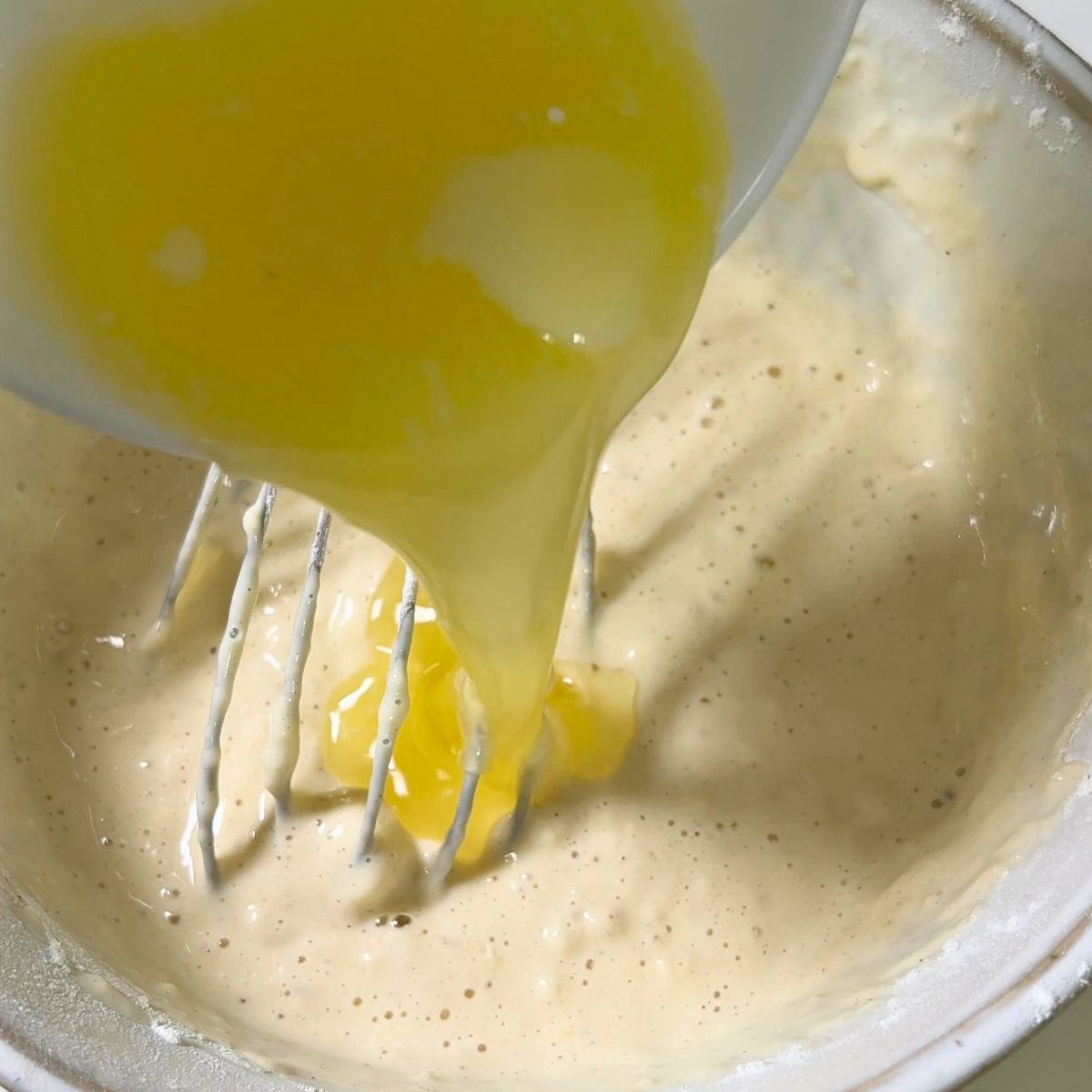 Adding melted butter to the buttermilk pancake.