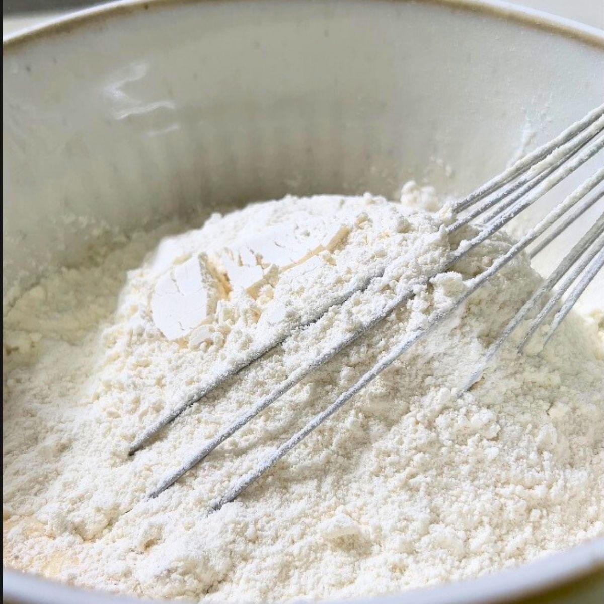 Adding flour mixture to the pancake batter.