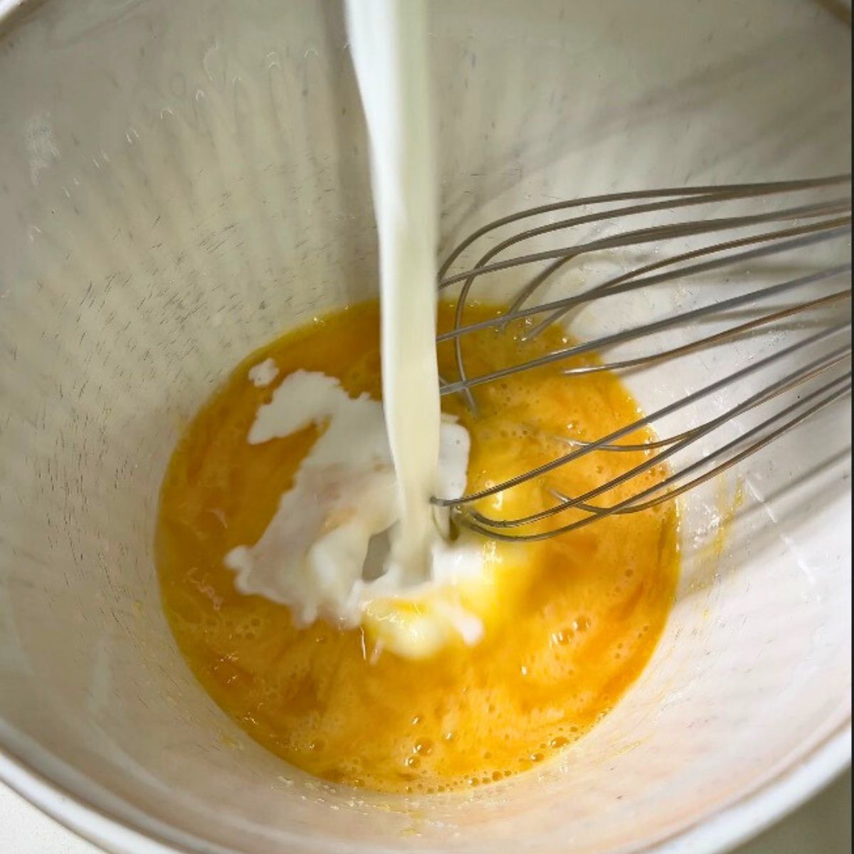 Mixing wet ingredients for pancake batter.