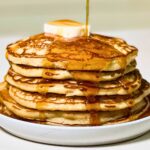 stack of homemade buttermilk pancakes with maple syrup