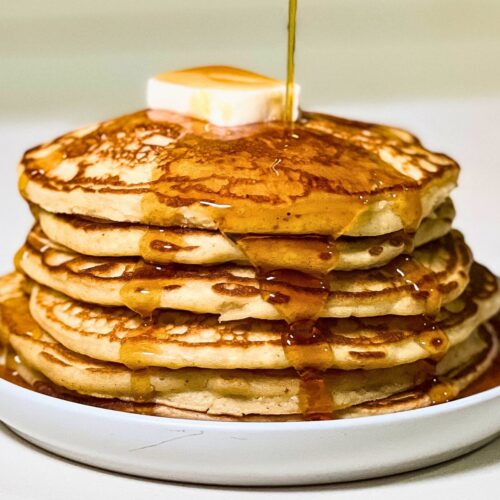 stack of homemade buttermilk pancakes with maple syrup