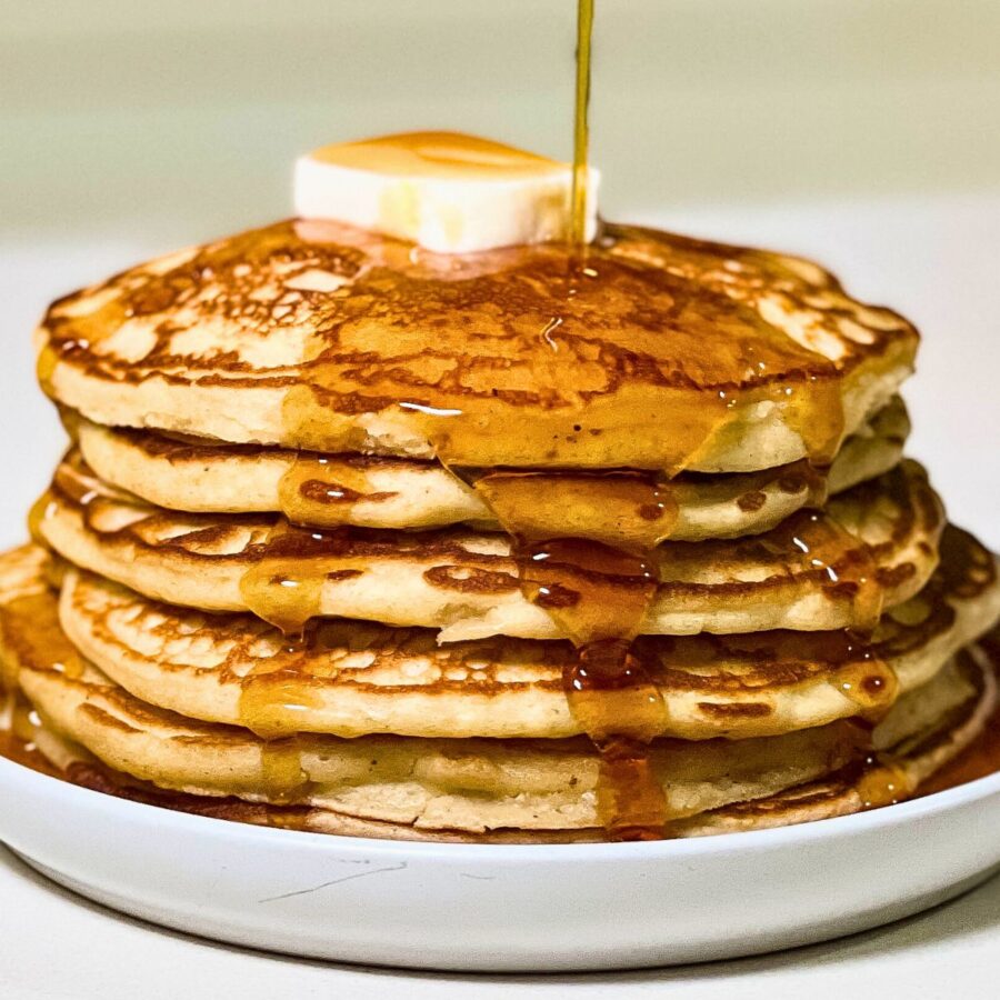 stack of homemade buttermilk pancakes with maple syrup