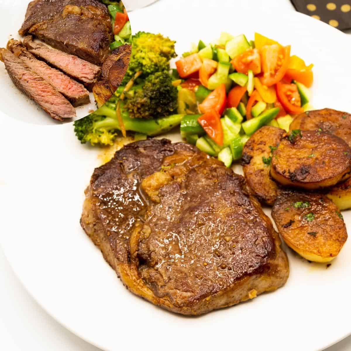 A plate with cooked steak potatoes and salad