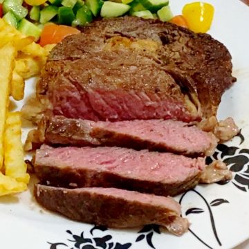 A plate with sliced medium rare steak.