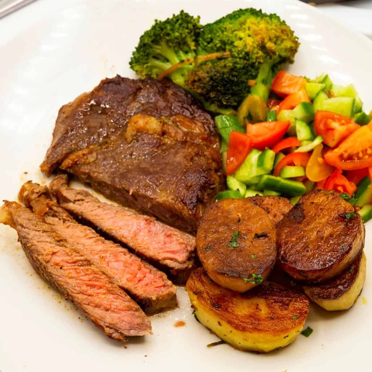 A plate with steak slices cooked medium.