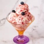 A ice cream dessert glass with strawberry.