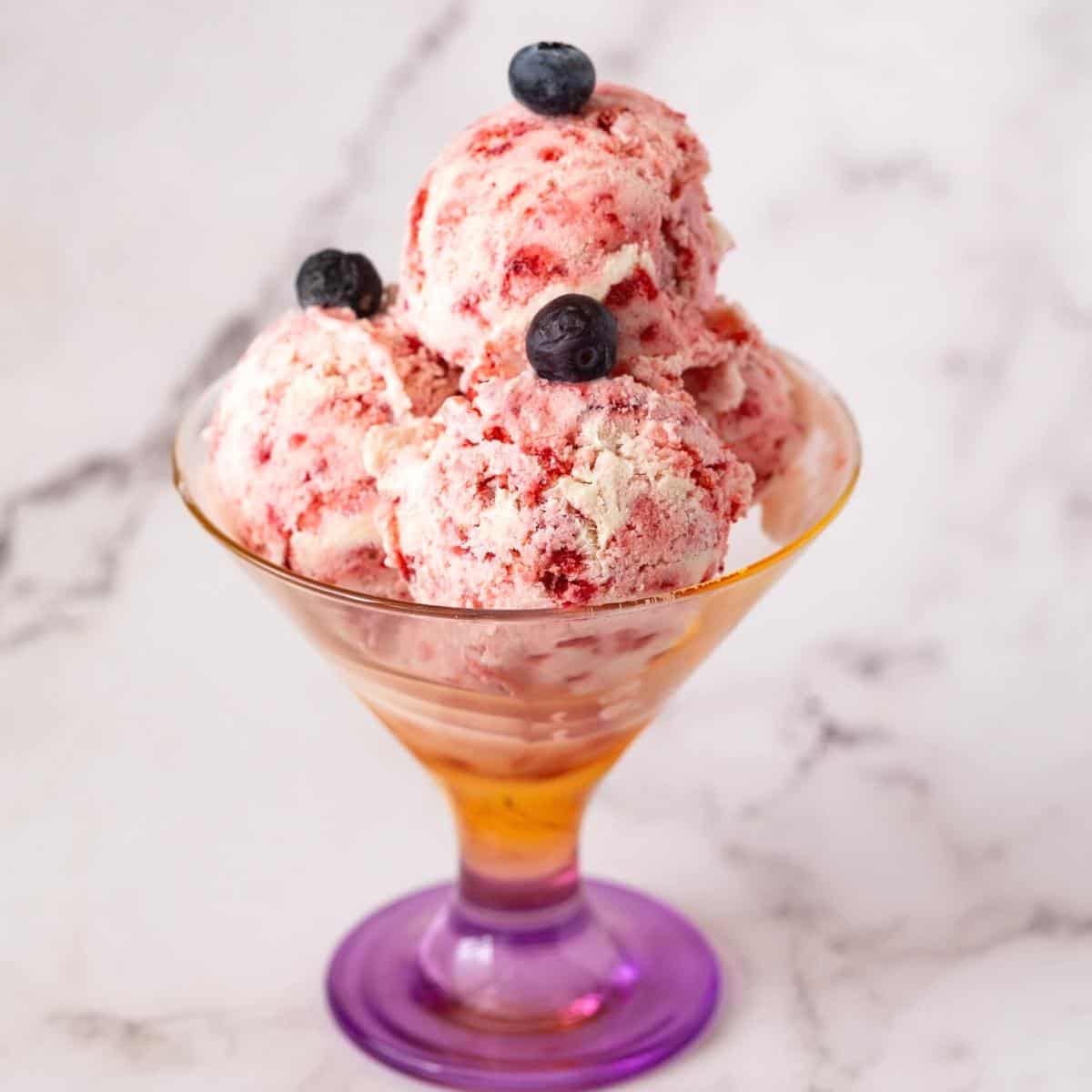 A ice cream dessert glass with strawberry.