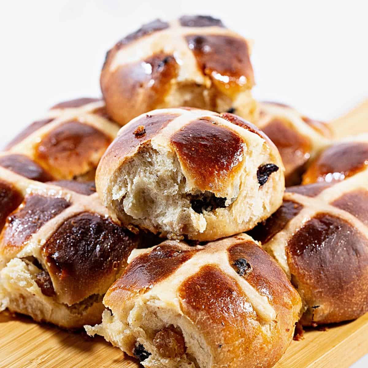 Spiced buns for Easter on the table with cross.