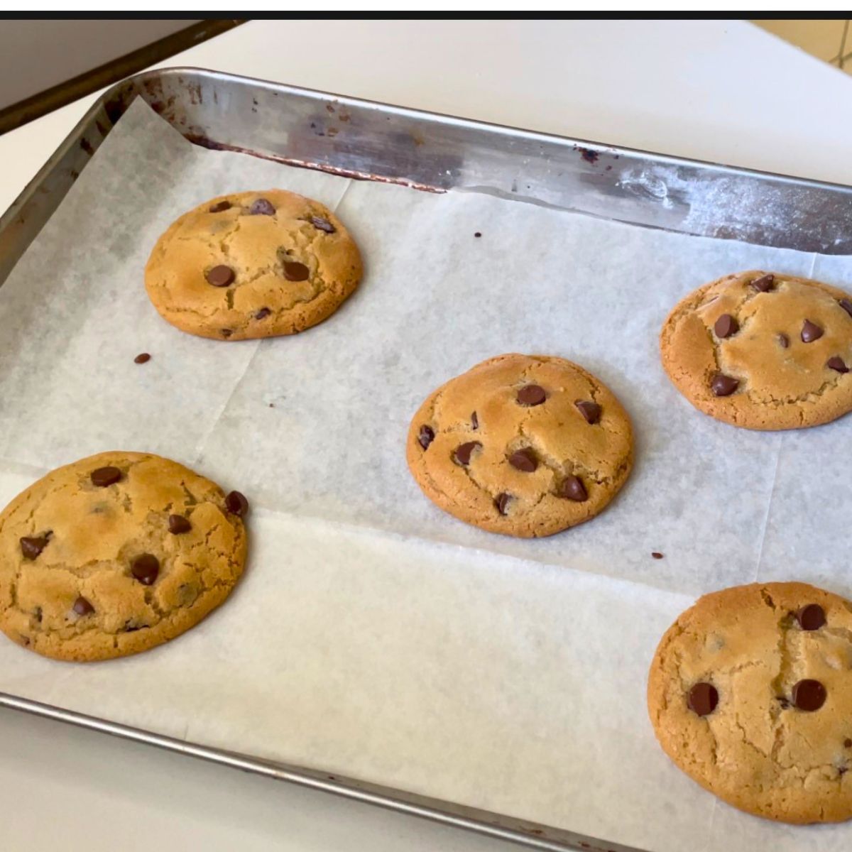A baking sheet with chocolate chip cookies.