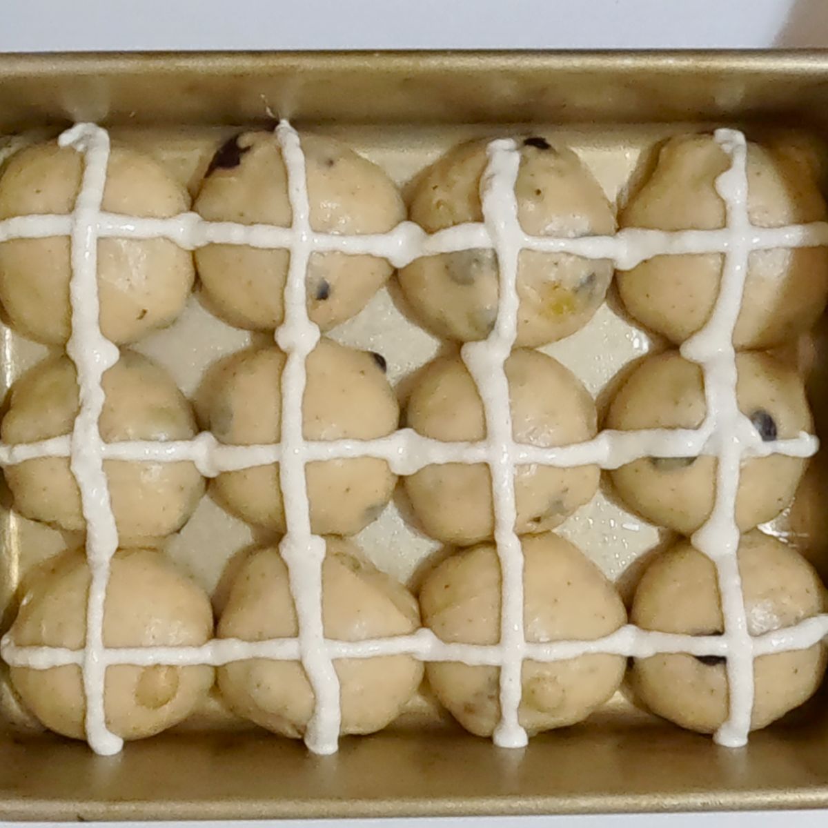 Sweet raisin buns with flour cross for Easter.
