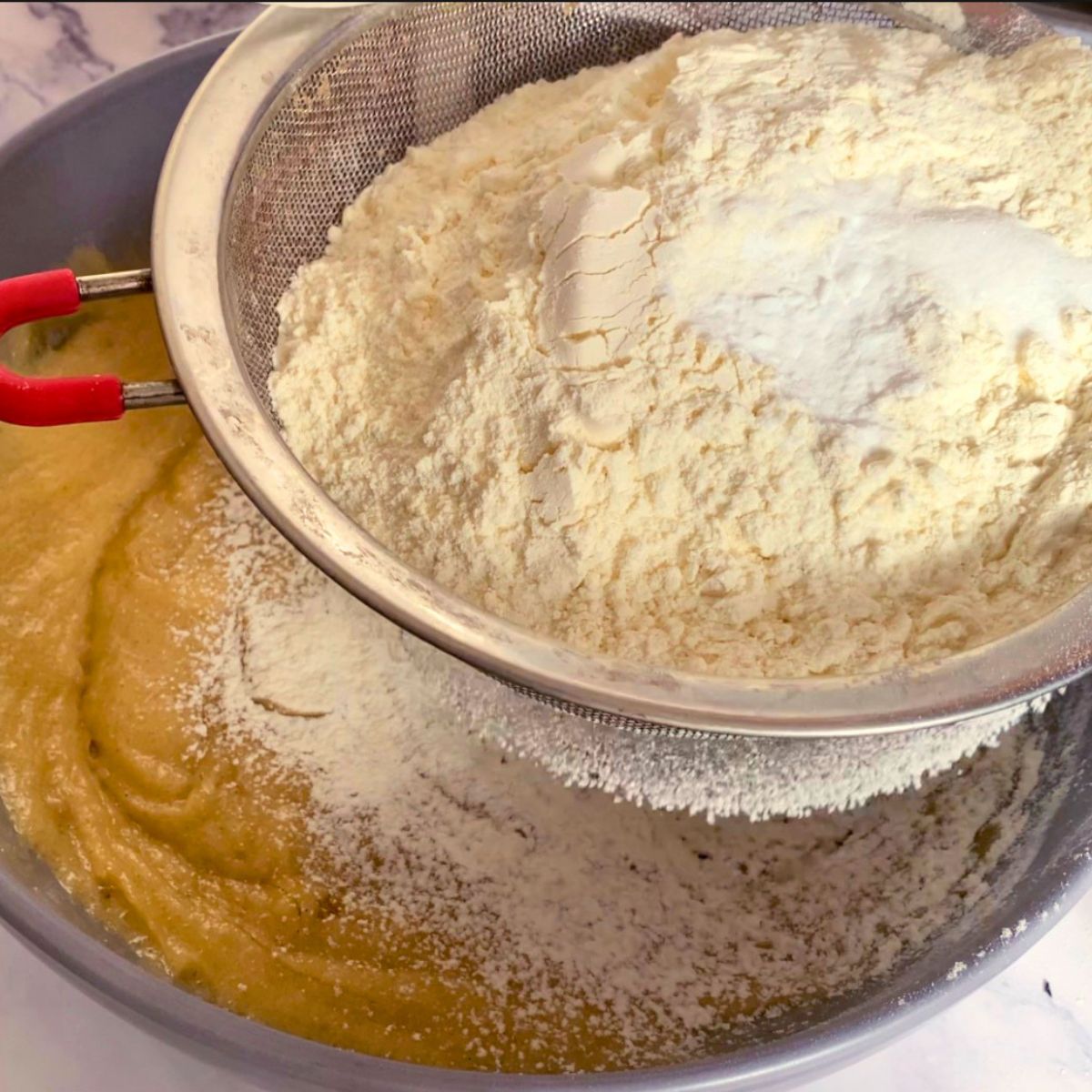 Adding flour and leavening to cookie dough.