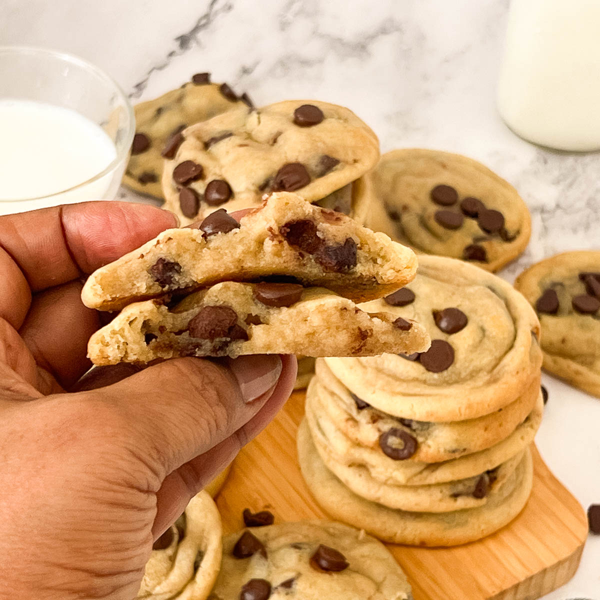 Hand showing the inside of the chocolate chip cookies.