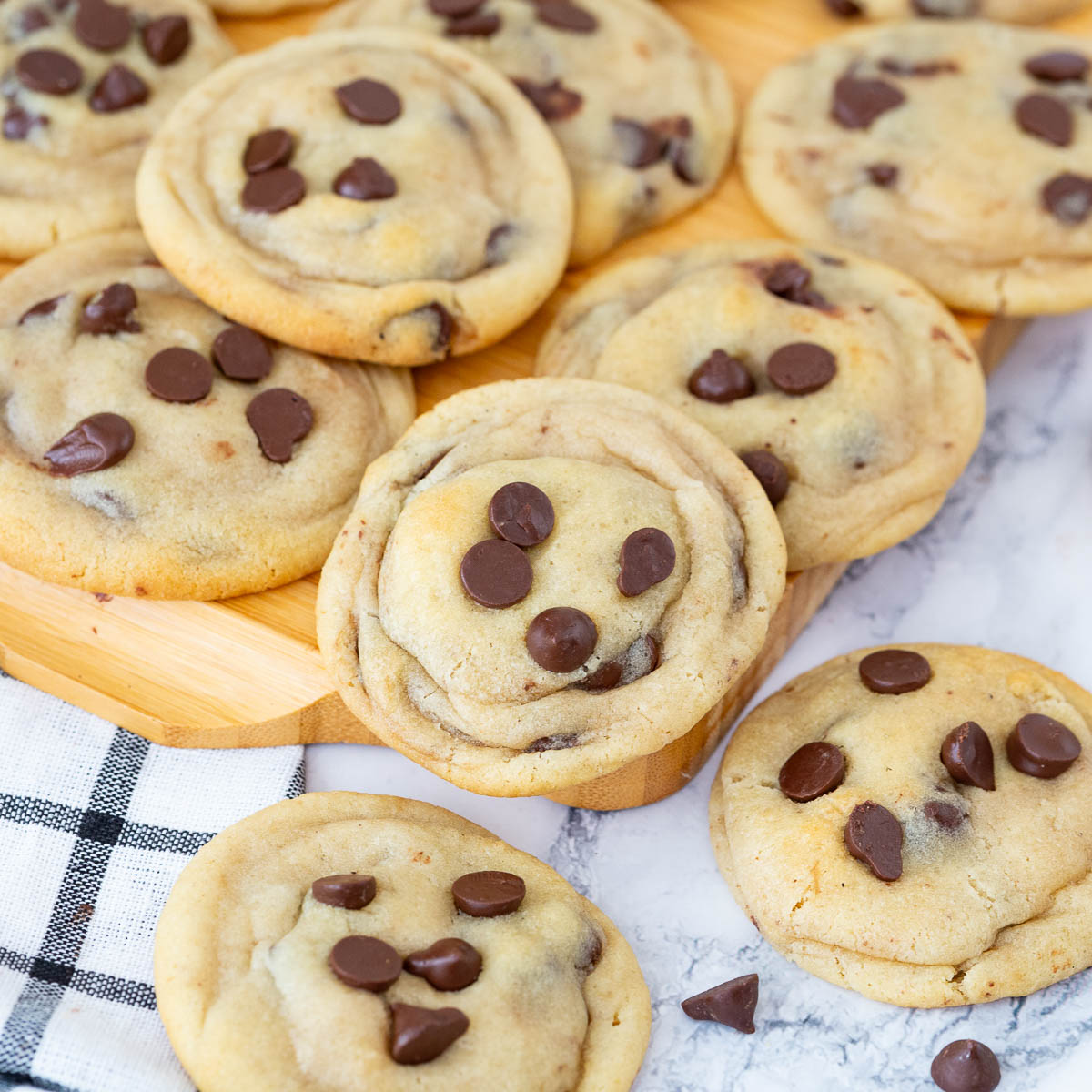 A spread of chocolate chip cookies on the table.