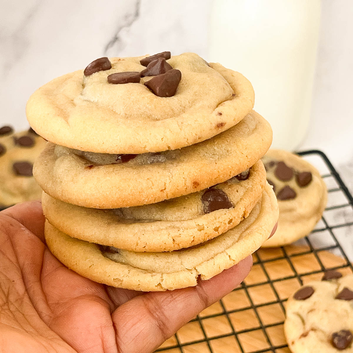 A stack of chocolate chip cookies on the table.
