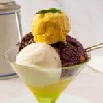 A glass with different flavors of no churn ice cream.