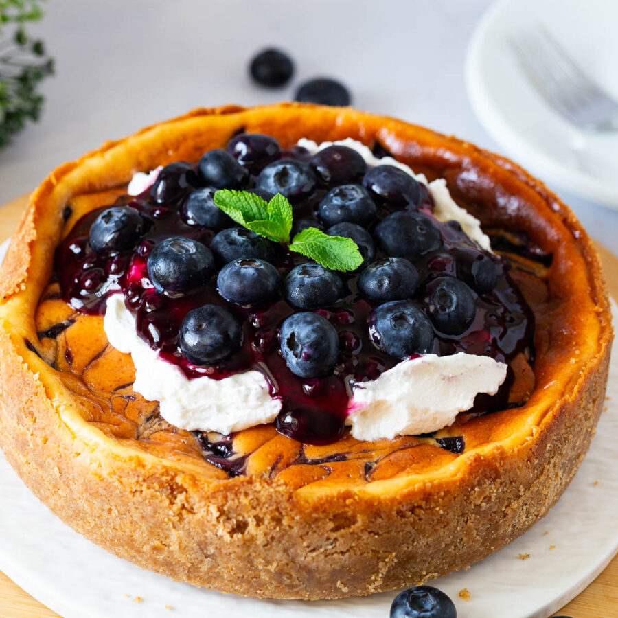 A cheesecake topped with fresh blueberries.