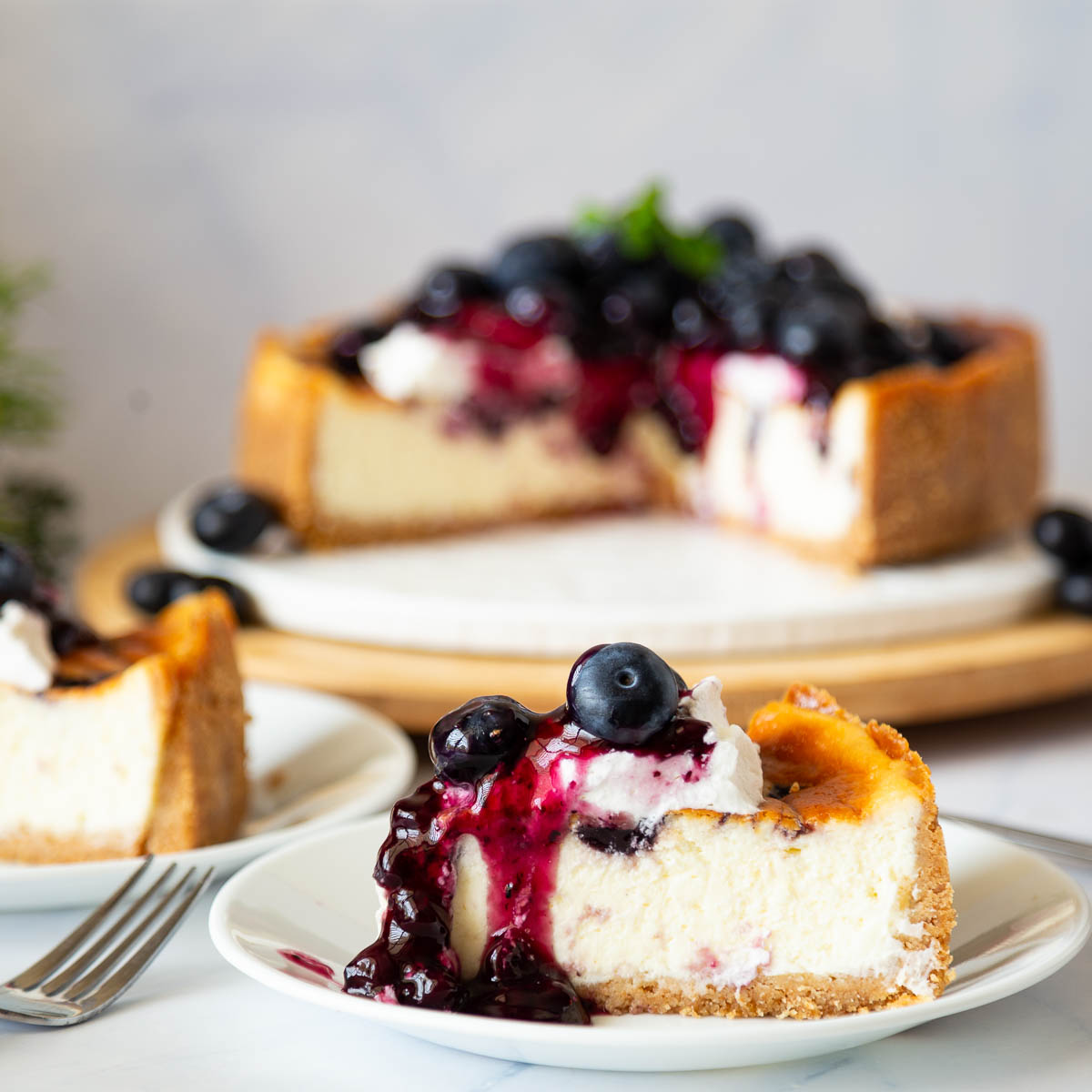 A sliced blueberry cheesecake on the table.