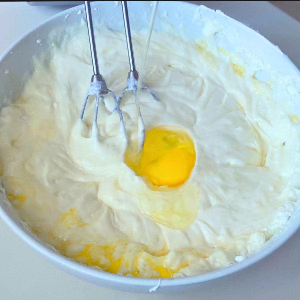 A mixing bowl with cheesecake batter.