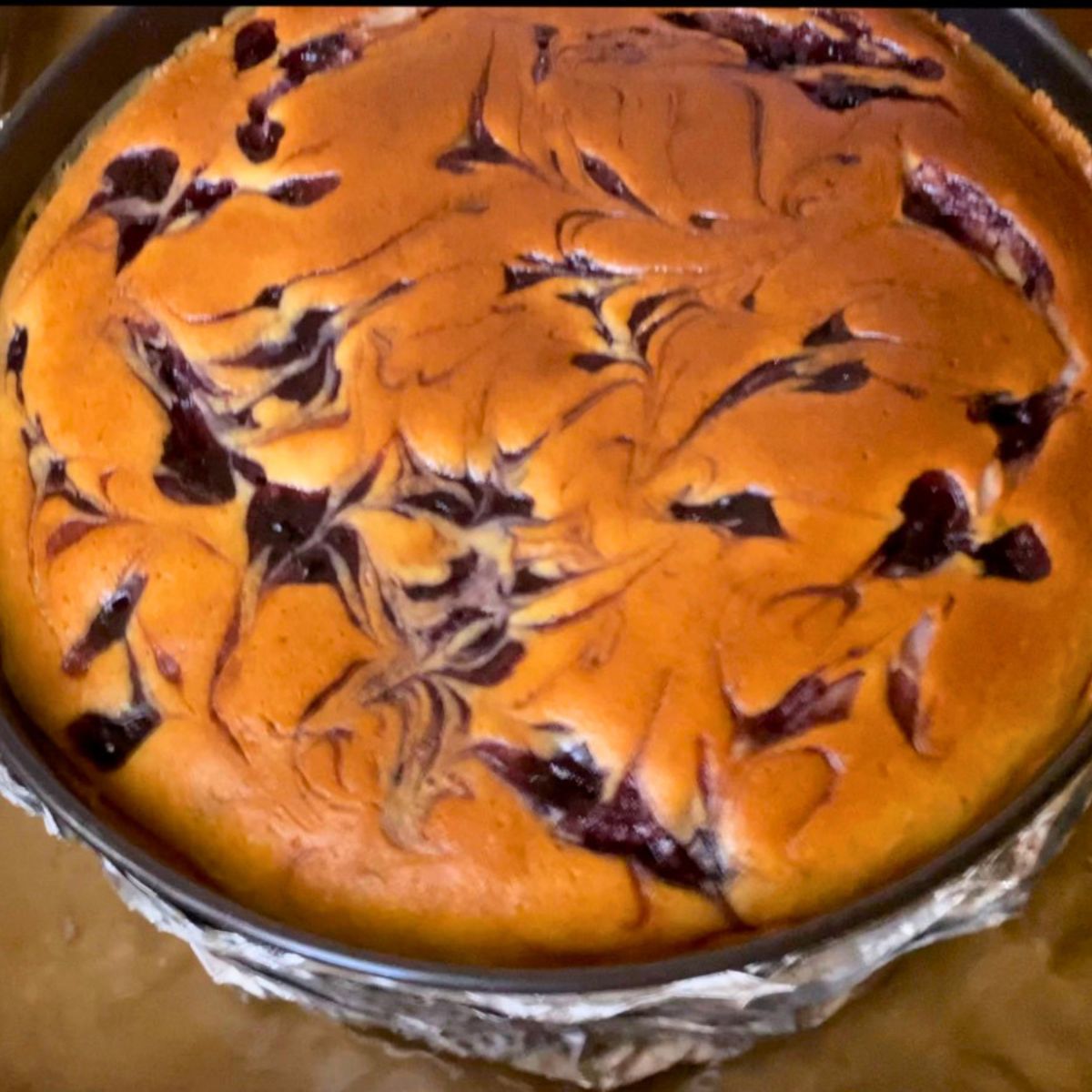 A baked cheesecake on in a spring form pan.