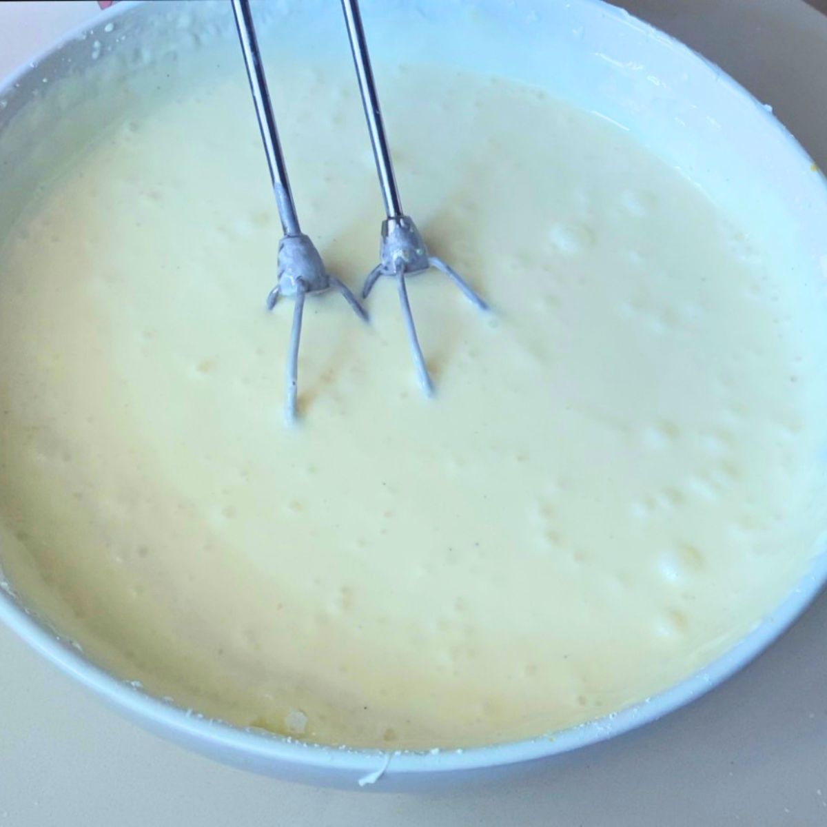 A mixing bowl with cheesecake batter.