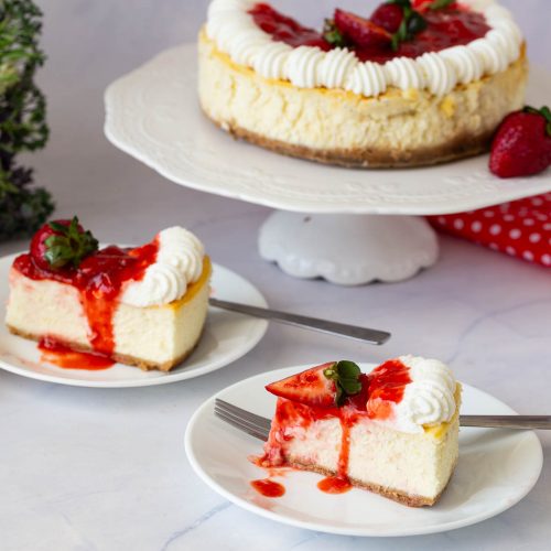 A frosted cheesecake on the table.
