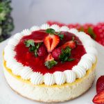 A cheesecake baked with strawberry on the table.