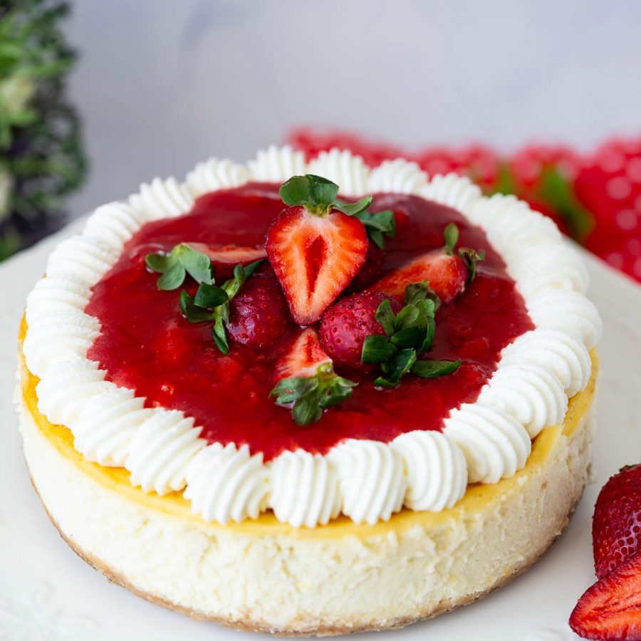 A cheesecake baked with strawberry on the table.