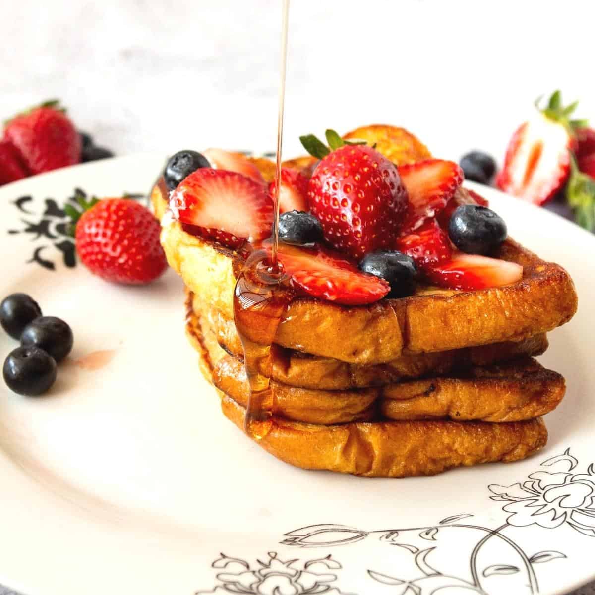Slices of Brioche French Toast on a white plate.
