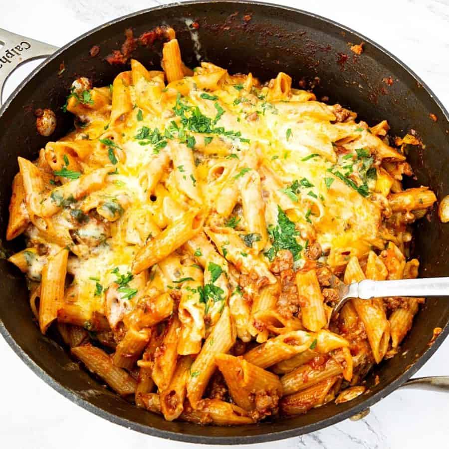 A skillet with ground beef and pasta.