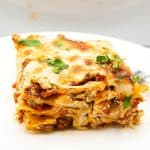 A slice of lasagna with ricotta on a plate