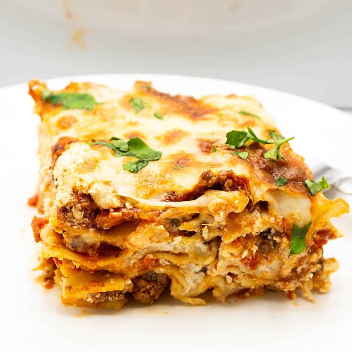 A slice of lasagna with ricotta on a plate