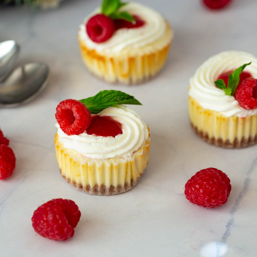 Raspberry cheesecakes on the table.
