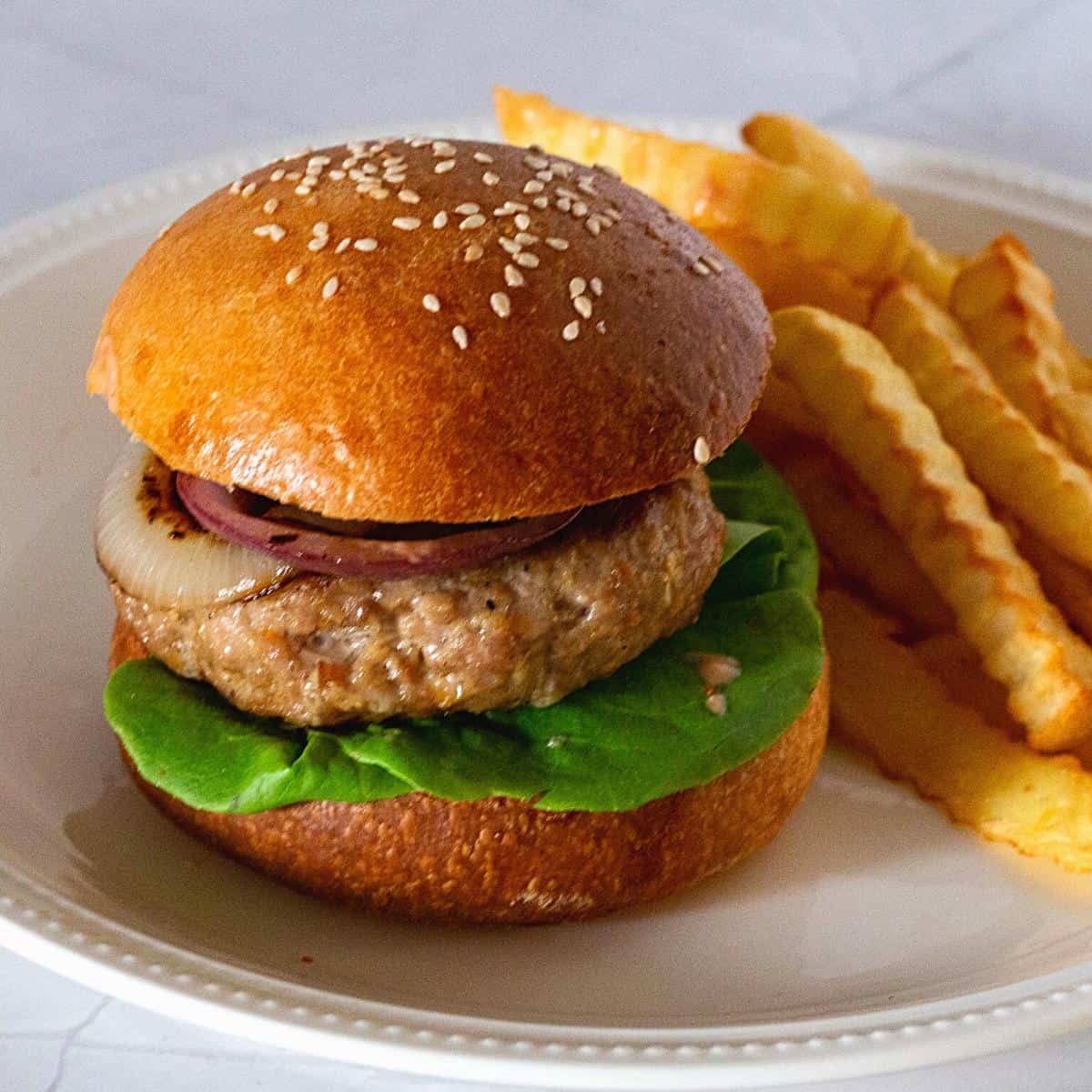 Burger on a plate with ground turkey.