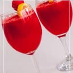 A tall glass with juice made watermelon and lemon.