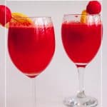 A tall glass with juice made watermelon and lemon.