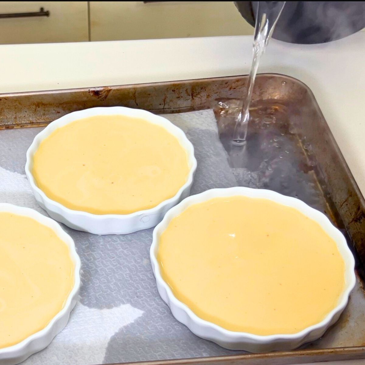 A tray for creme brulee ramekins on a baking tray.